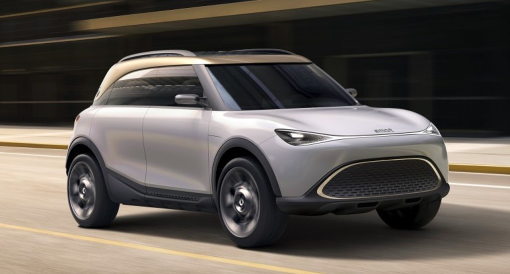 A silver Smart Concept #1 electric crossover vehicle driving on the road. 