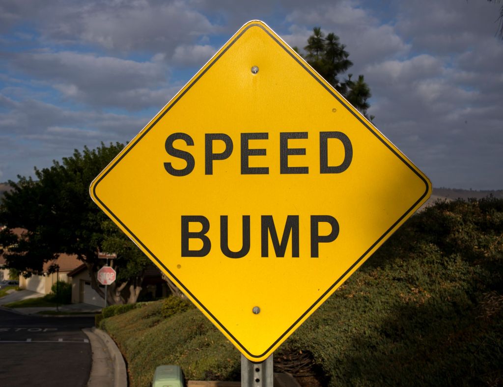 Yellow Speed Bump sign along a highway. 