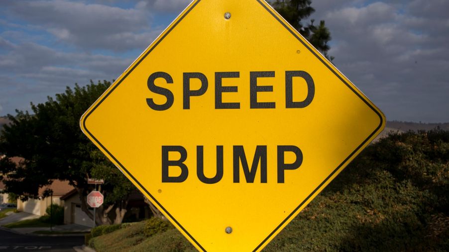 Yellow Speed Bump sign along a highway.