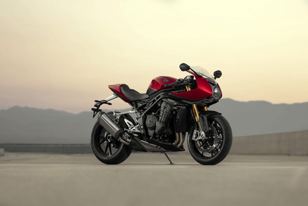 A red-and-black 2022 Triumph Speed Triple 1200 RR on a desert racetrack
