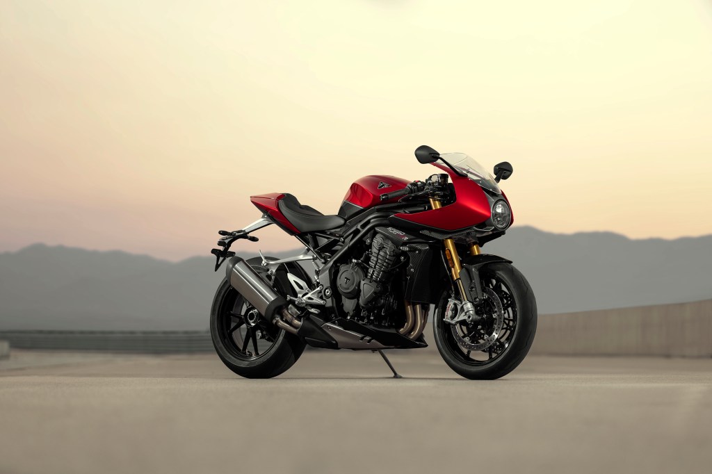 A red-and-black 2022 Triumph Speed Triple 1200 RR on a desert racetrack