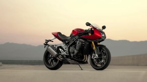 A red-and-black 2022 Triumph Speed Triple 1200 RR on a desert racetrack