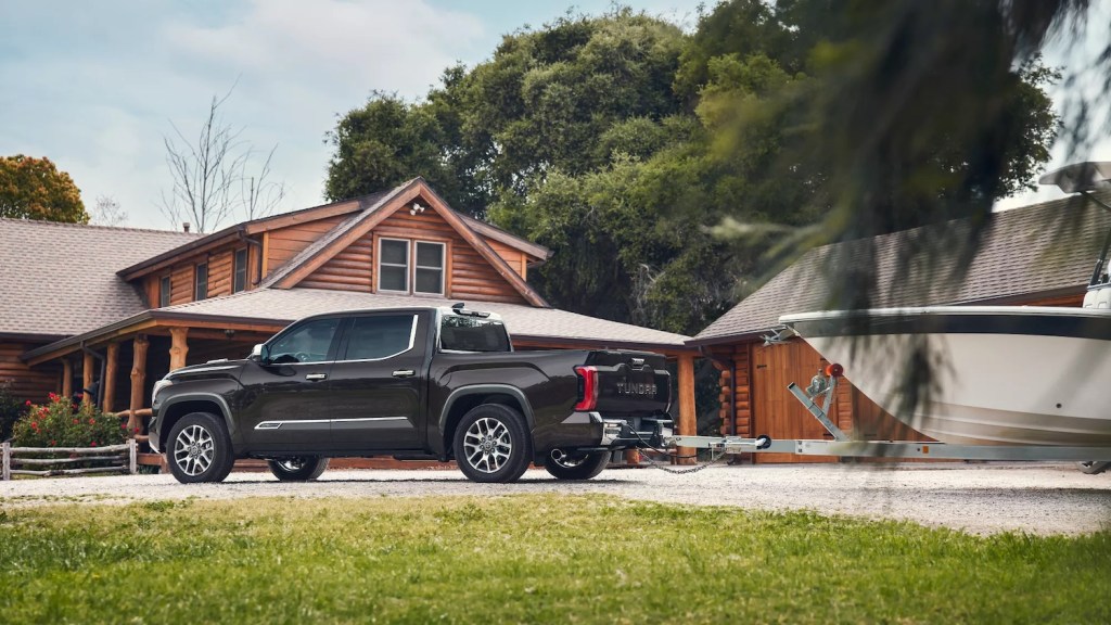 This is a promo photo of the 2022 Toyota Tundra towing capacity tested as a gray truck tows a boat.