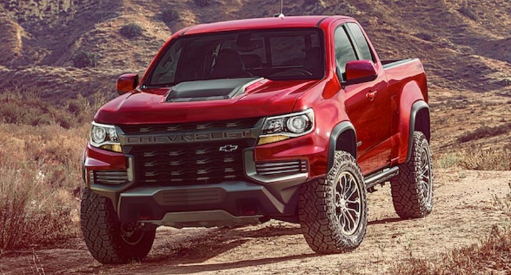 A red 2021 Chevy Colorado ZR2 off-road truck is parked in nature. 