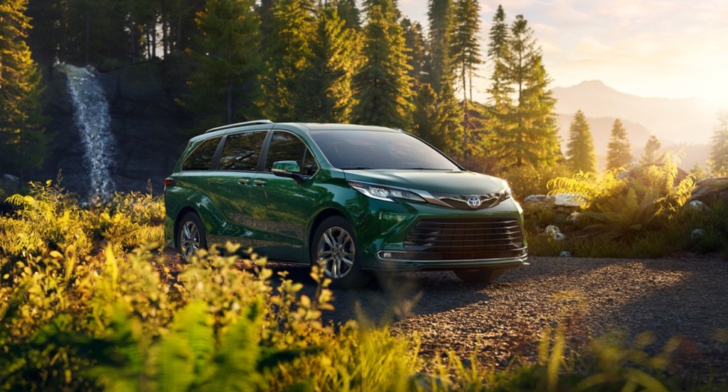 A green 2022 Toyota Sienna minivan is parked in nature.