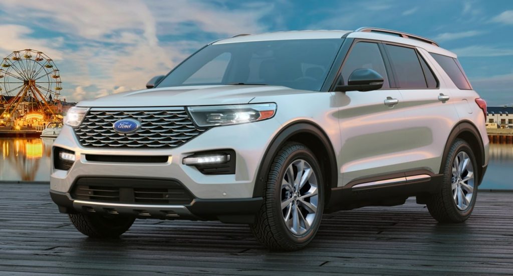 A white Ford Explorer is parked on a boardwalk. 