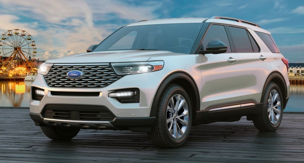 A silver Ford Explorer parked outside with a sunset background