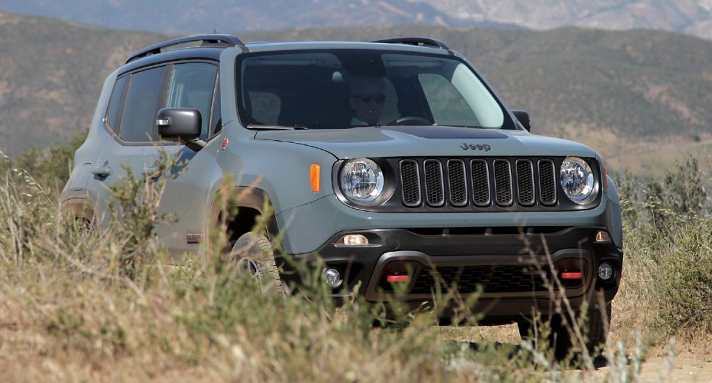 A green Jeep Renegade Trailhawk off-road SUV is in nature.