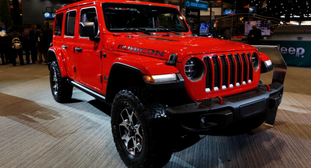 A red Jeep Wrangler Rubicon is on display.