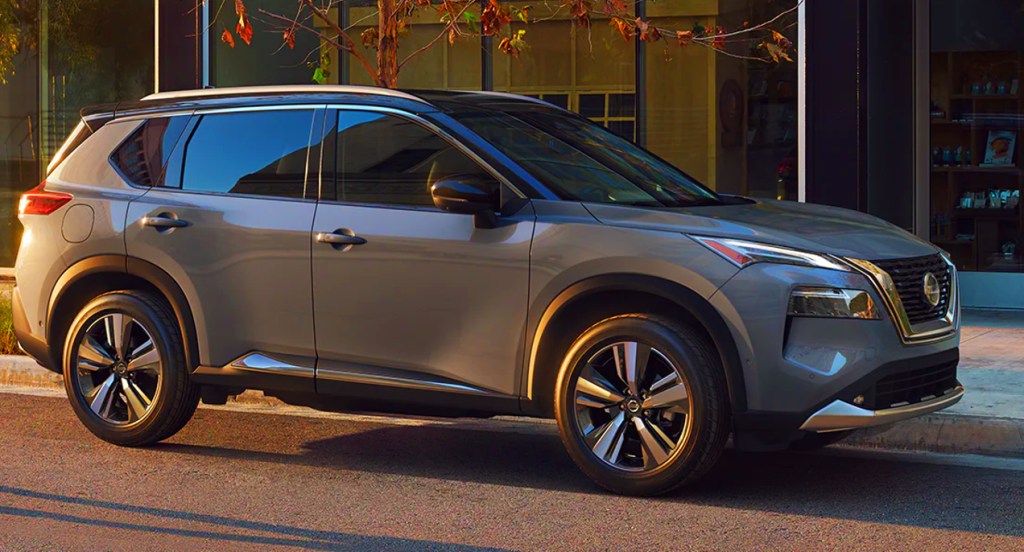 A gray Nissan Rogue compact SUV is parked on the street.