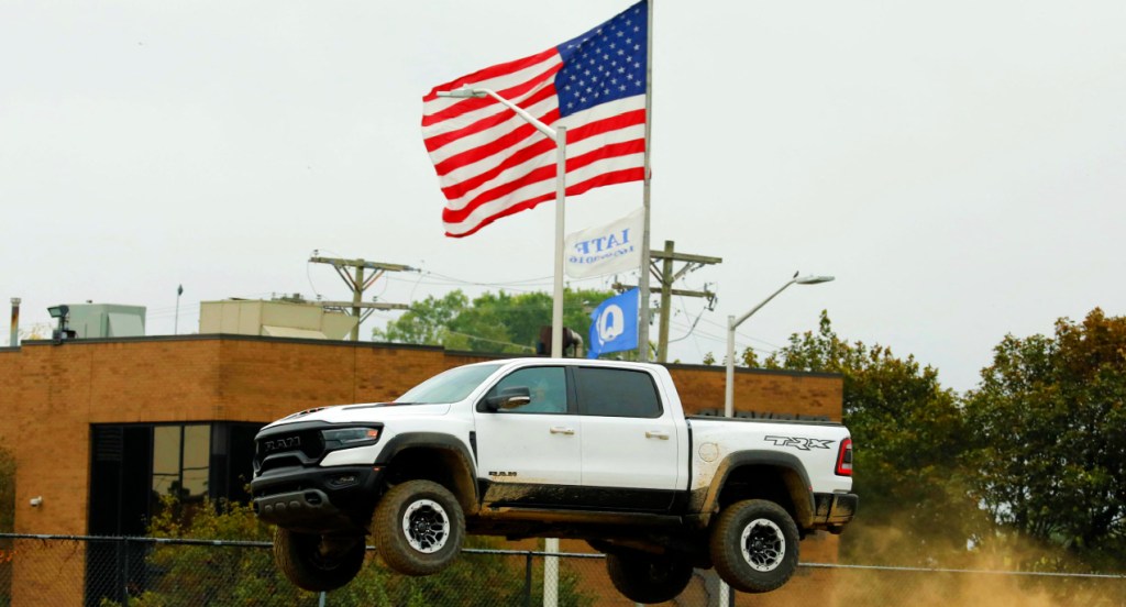 A white Ram 1500 TRX pickup truck on a test track during the Motor Bella event in Pontiac, Michigan on September 21, 2021.