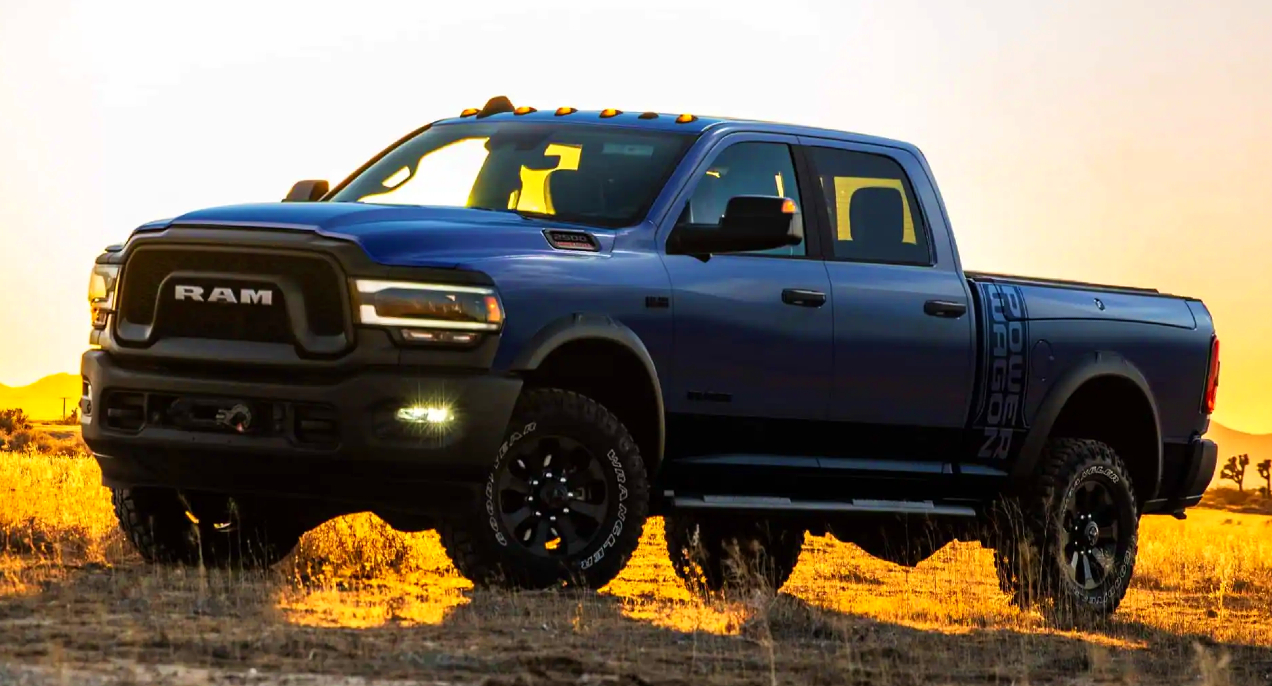 A Ram 2500 Power Wagon parked in a field during a sunset