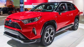 A red Toyota RAV4 Prime is on display.