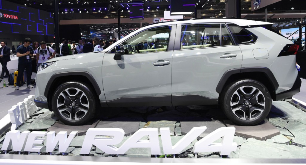 A gray Toyota Rav4's side profile is on display at an autoshow. 