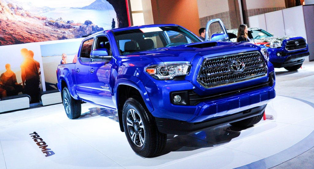 A blue Toyota Tacoma pickup truck is on display. 