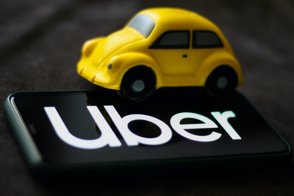 Uber logo displayed on a phone screen is seen in this illustration