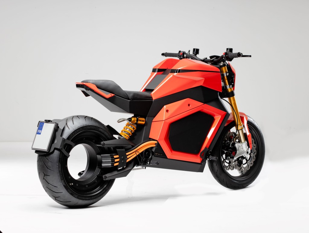 The rear 3/4 view of an orange-and-black Verge TS electric motorcycle