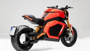 The rear 3/4 view of an orange-and-black Verge TS electric motorcycle
