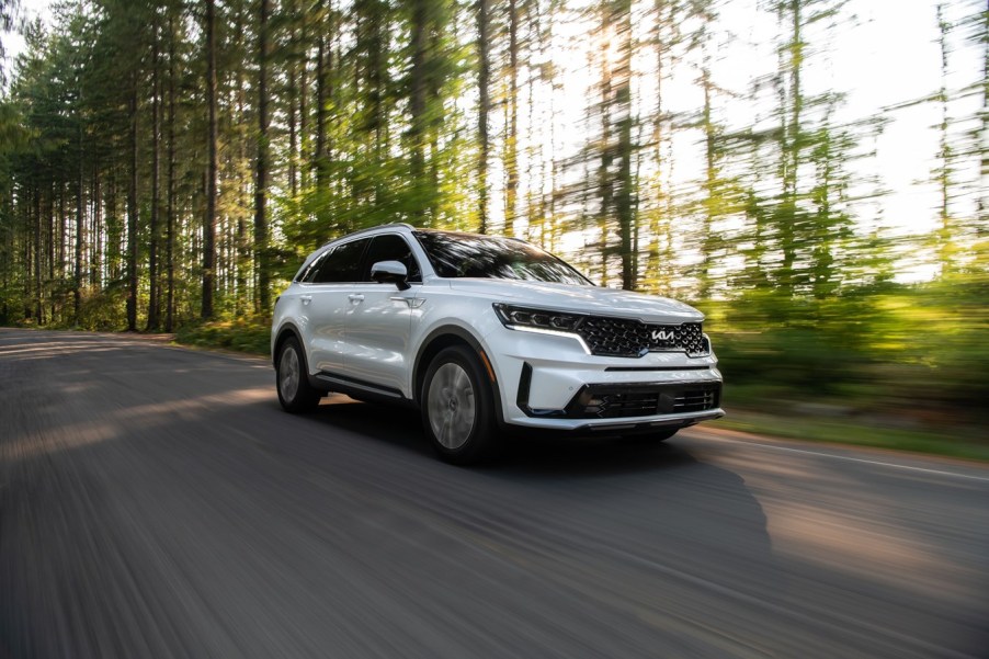 White 2022 Kia Sorento Plug-In Hybrid driving through a forest