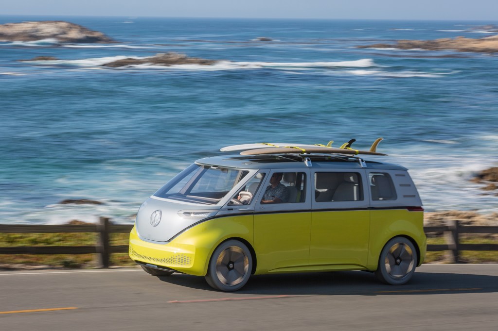 Yellow and white Volkswagen ID. Buzz concept van driving on a coastal road