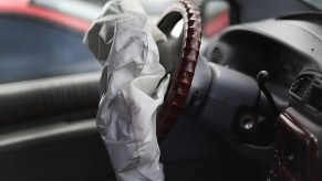 A deployed air bag sagging in front of a steering wheel. Similar to the kind seen in the airbag recall