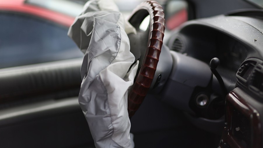 A deployed air bag sagging in front of a steering wheel. Similar to the kind seen in the airbag recall