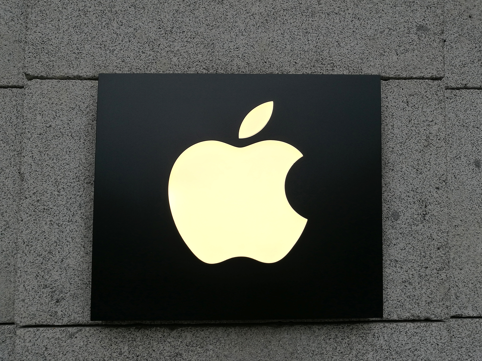 The Apple Logo on a lit sign outside of an Apple Store. Is it possible that the Apple Car is revealed in 2021?