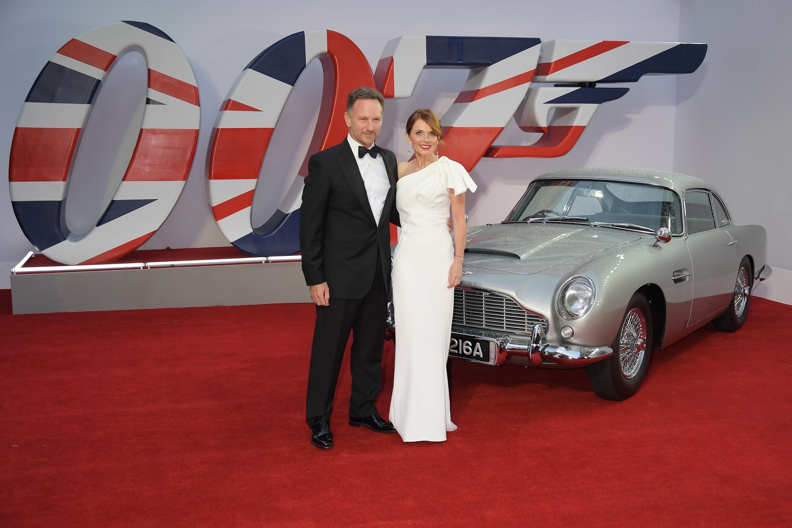 Christian and Geri Horner at the "No Time to Die" premier, with an Aston Martin DB5 in the background