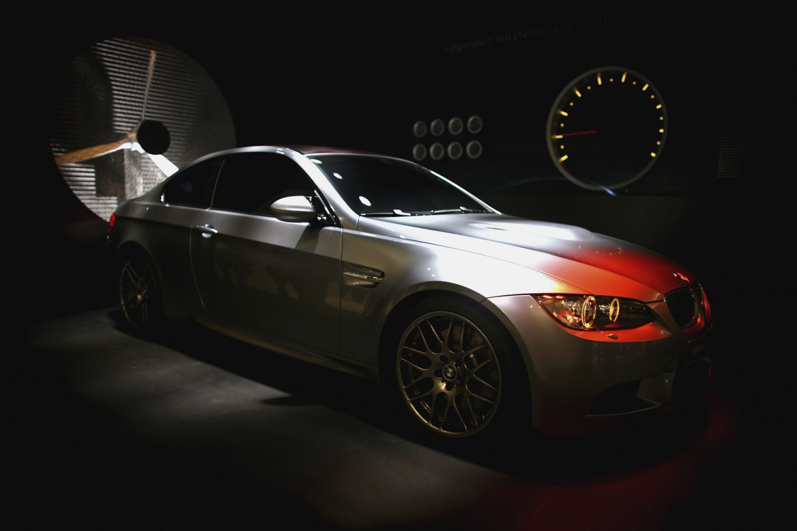 A silver E92 generation BMW M3 shot in the shadows from the front 3/4