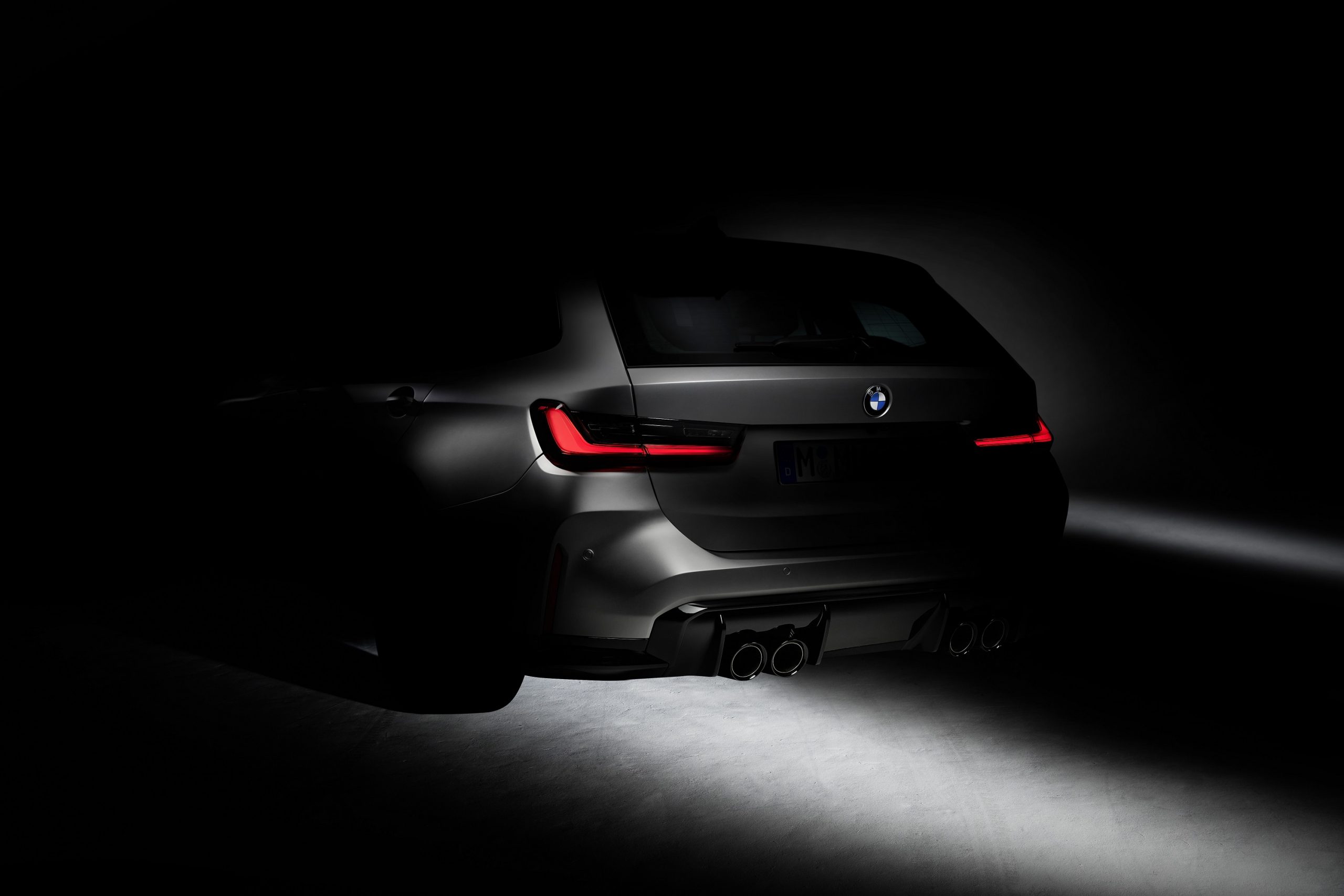 The silhouette of the 2022 BMW M3 touring shot from the rear 3/4 angle