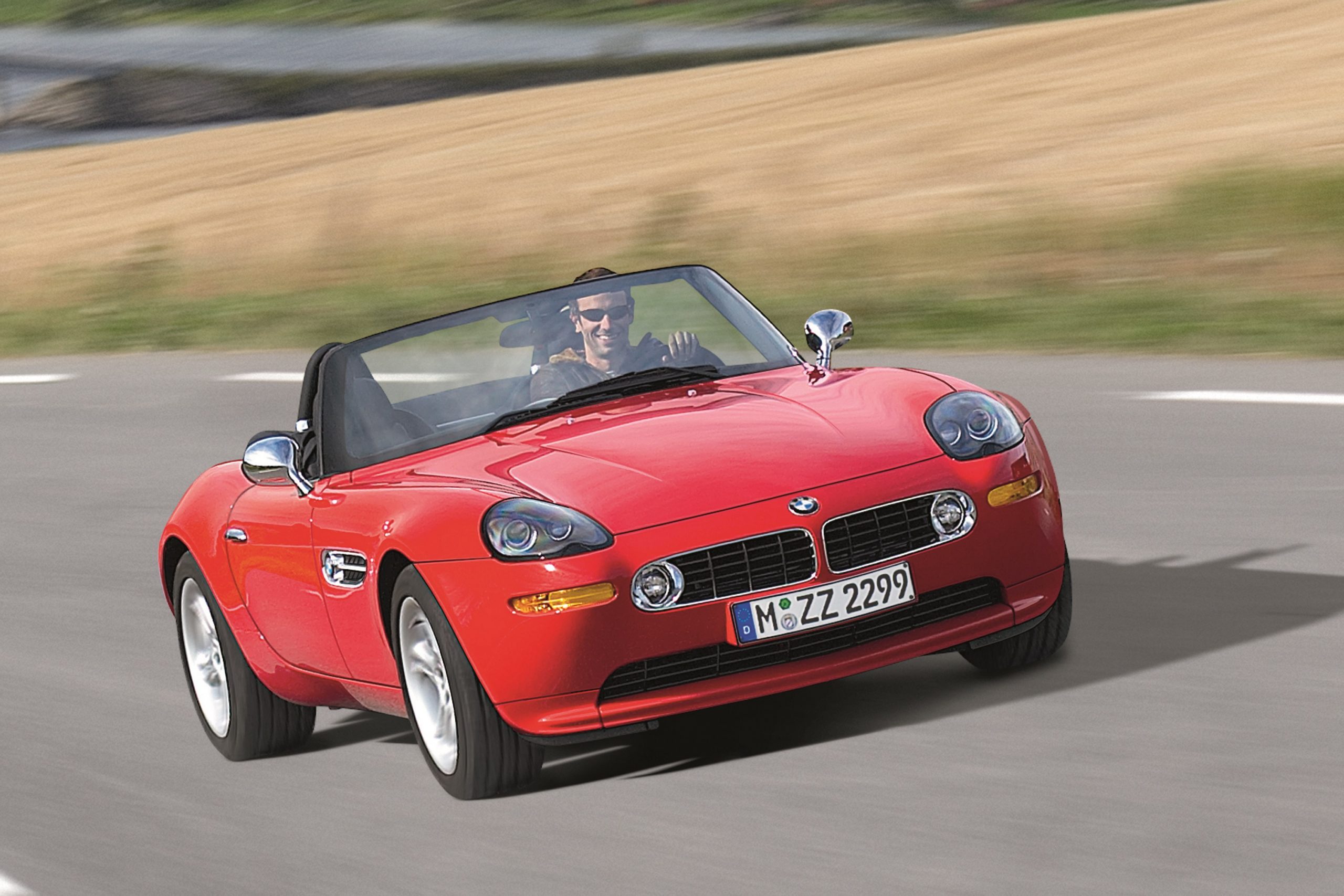A red BMW Z8 convertible shot in motion from the front