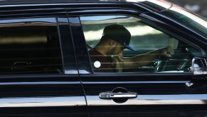 A distracted driver staring at his phone while behind the wheel of a car
