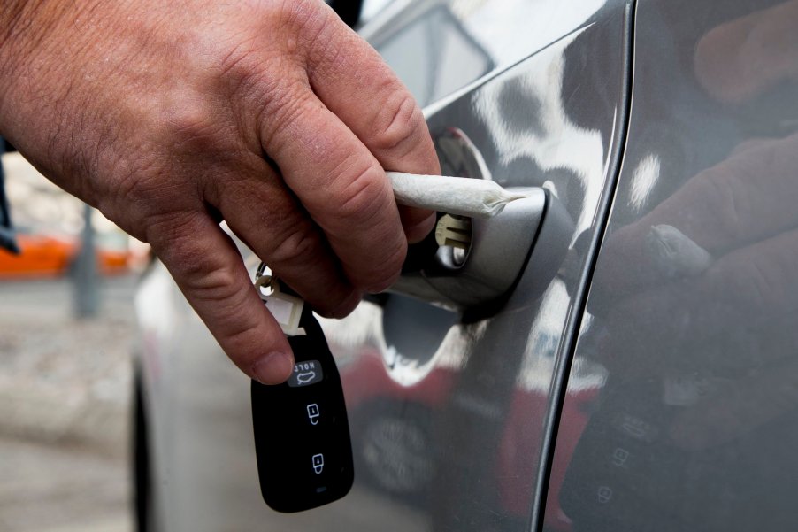Reenactment of a man too stoned to drive opens a car door while holding a marijuana blunt
