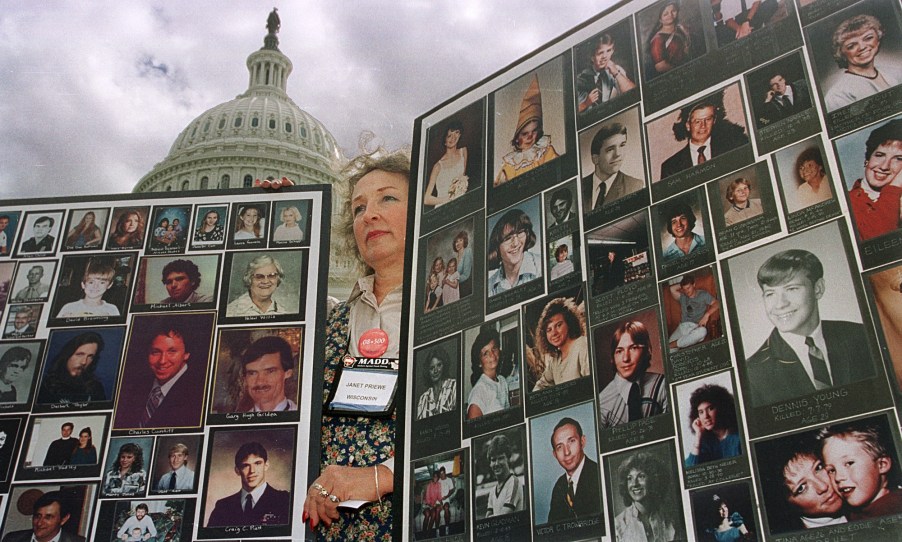 Mothers Against Drunk Driving volunteer Janet Priewe of Wisconsin holds up picture posters of drunk driving victims