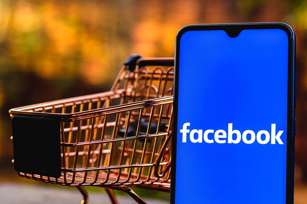  a Facebook logo seen displayed on a smartphone along with a shopping car