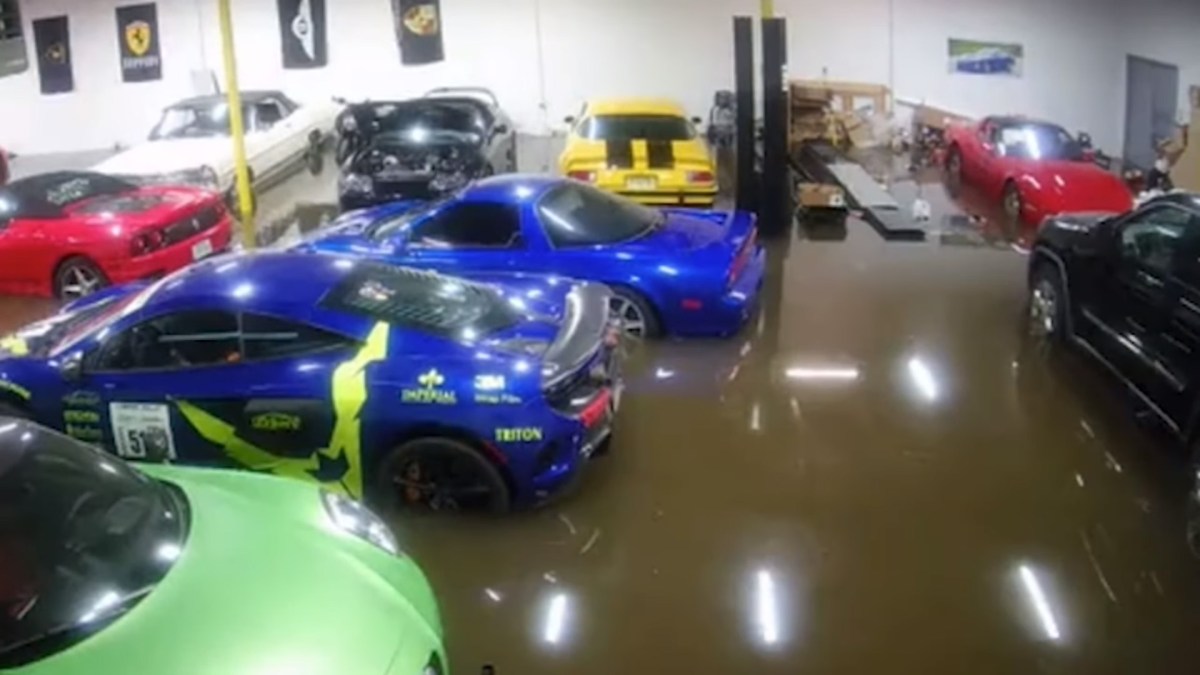 A screenshot from a security camera feed of Rob Feretti's warehouse full of supercars being flooded by Hurricane Ida.
