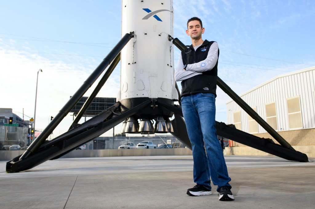 Inspiration4 mission commander Jared Isaacman, founder and chief executive officer of Shift4 Payments, stands for a portrait in front of the recovered first stage of a Falcon 9 rocket at Space Exploration Technologies Corp.