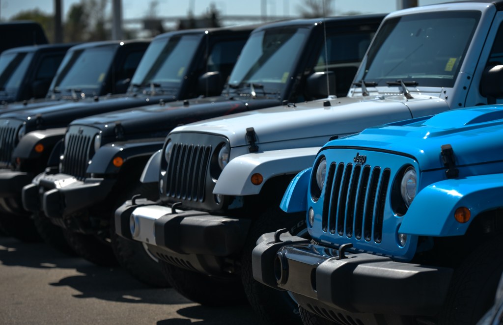 New Jeep vehicles parked outside a Chrysler, Jeep, Dodge, and RAM dealership in South Edmonton.