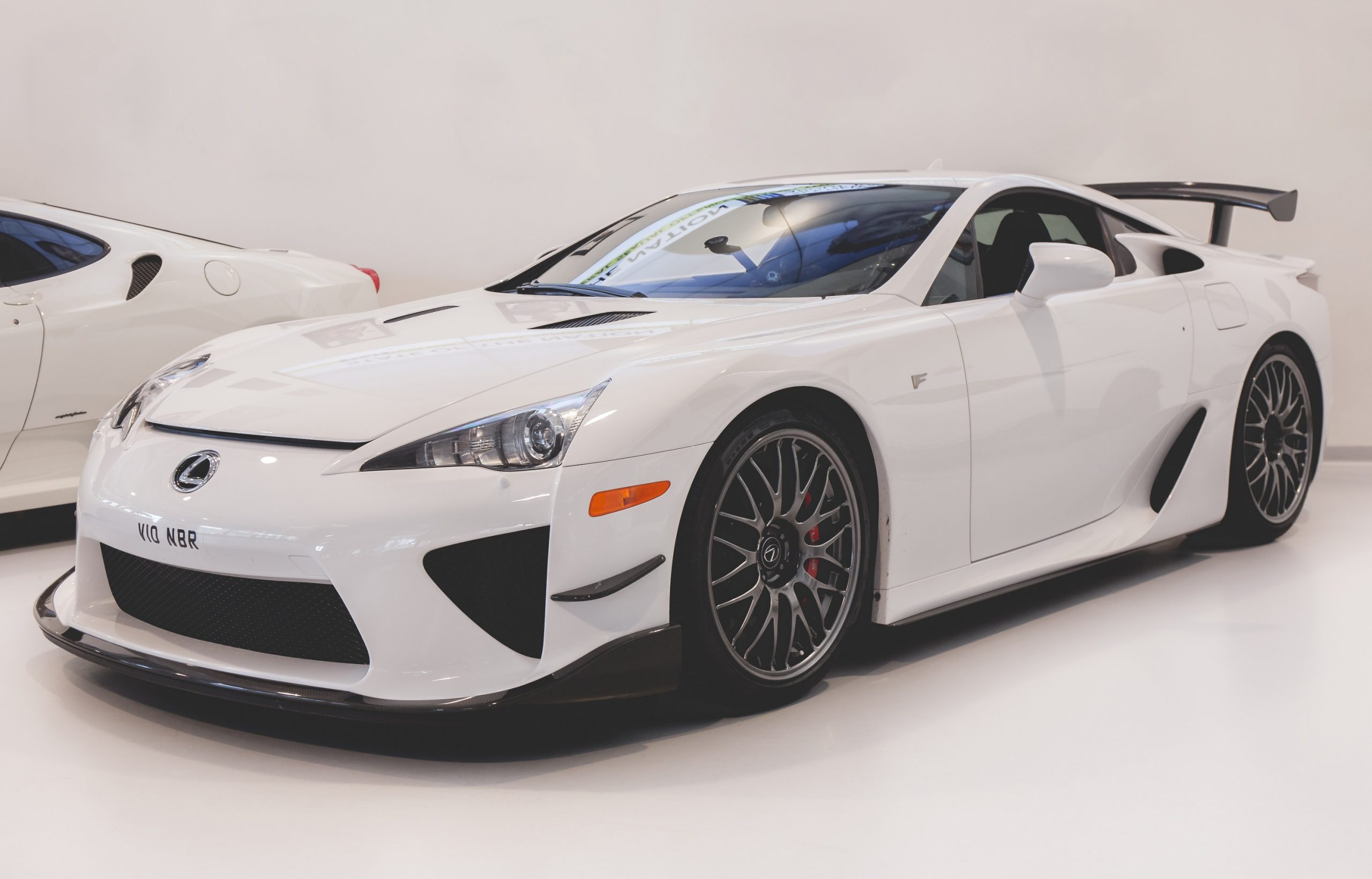 A white Lexus LFA Nurburgring edition shot from the front 3/4 angle