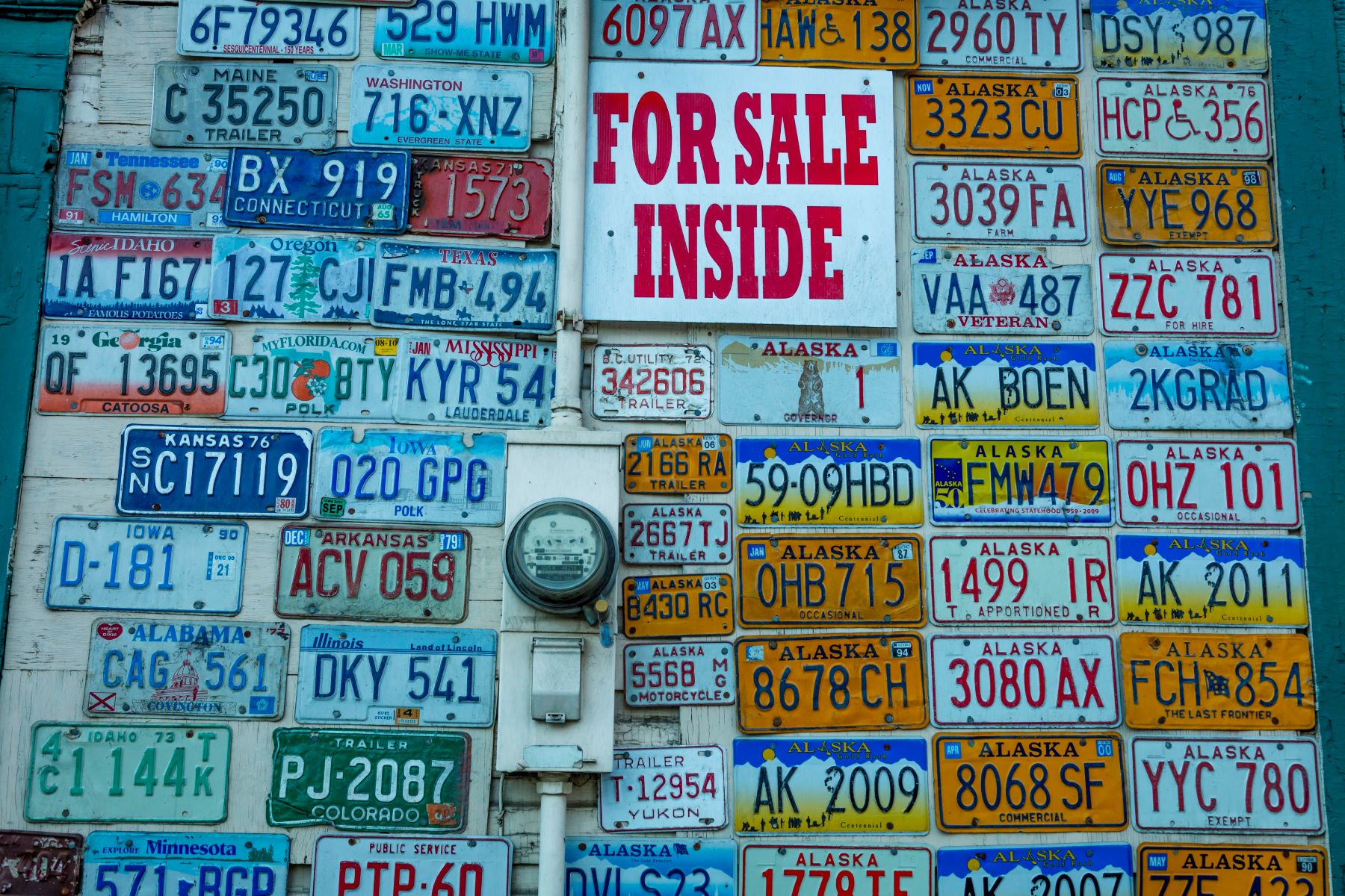 A wall of old license plates on a gift shop in Fairbanks, Alaska