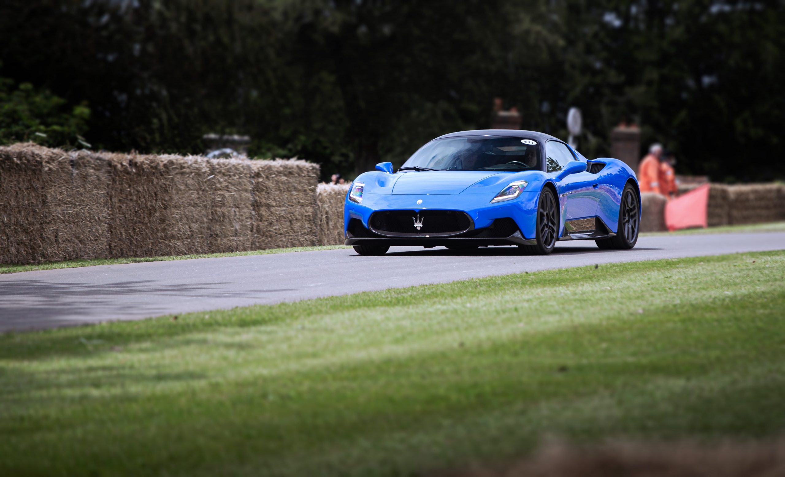 A blue Maserati MC20 shot from the front 3/4 at the Goodwood Festival of Speed