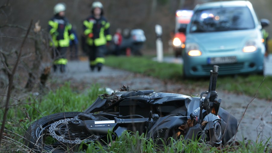 A crashed motorcycle on the side of the road