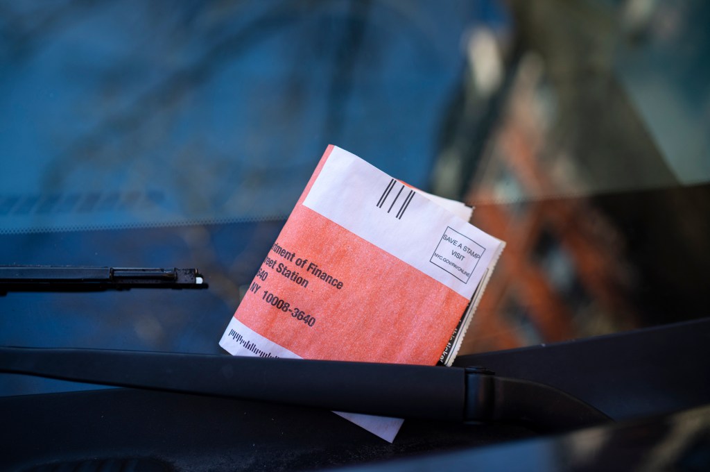 A parking ticket on the windshield of a vehicle in New York City