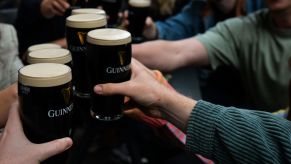 A group of friends drinking Guinness beer in a pub in Dublin, Ireland