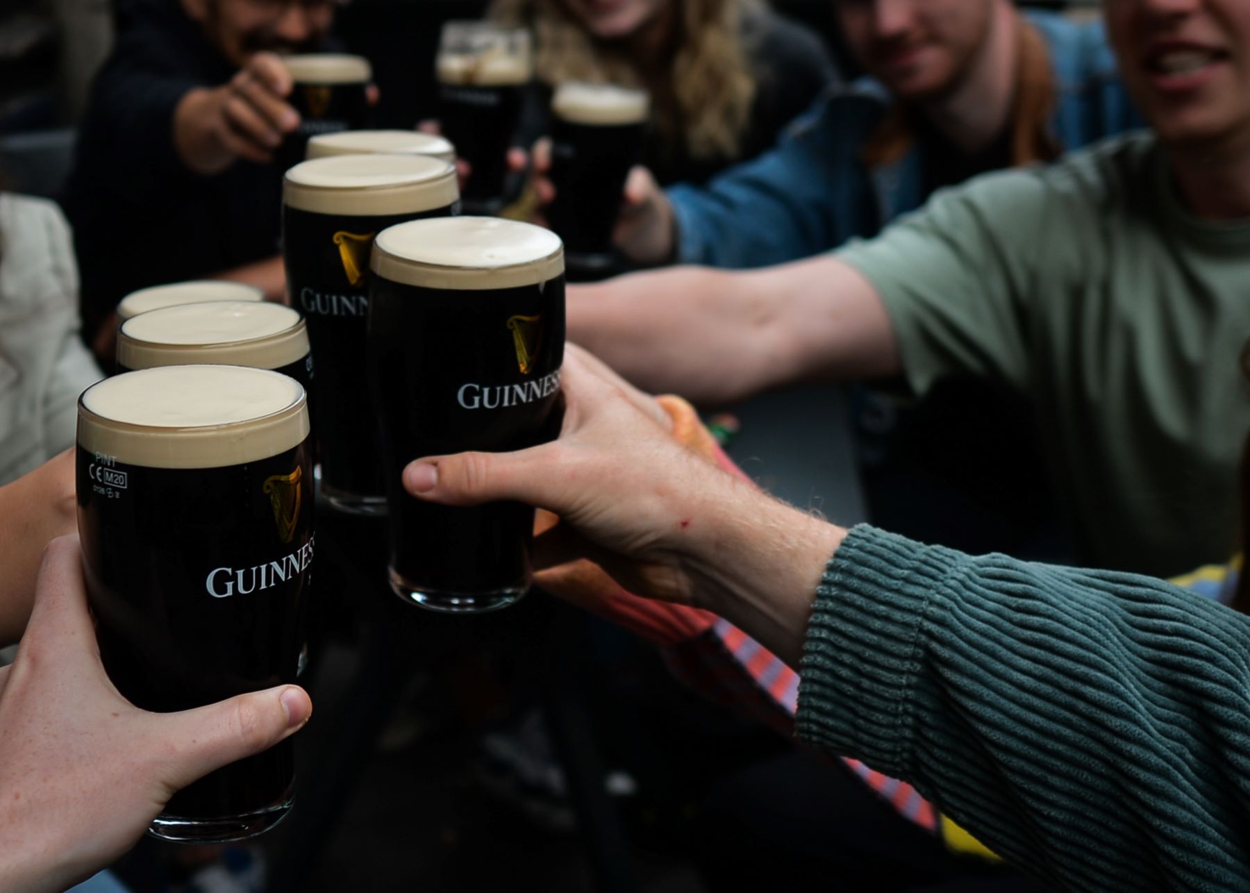 A group of friends drinking Guinness beer in a pub in Dublin, Ireland