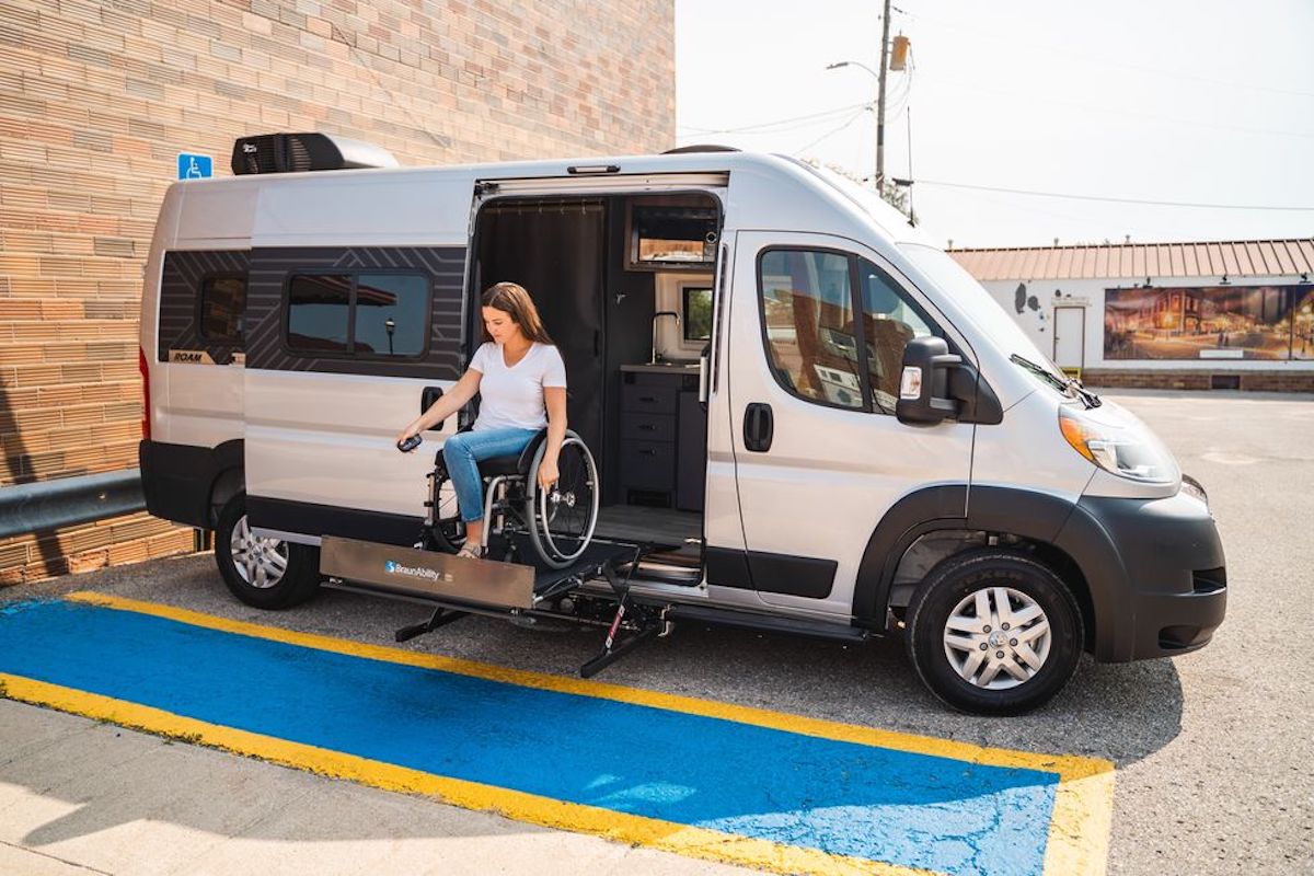 a woman using the lift in the new wheelchair accessible Winnebago Roam