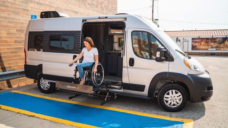 a woman using the lift in the new wheelchair accessible Winnebago Roam