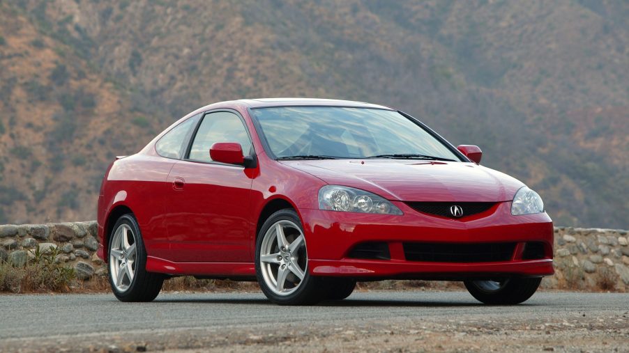 A red Acura RSX Type S shot from the front 3/4 on a canyon road