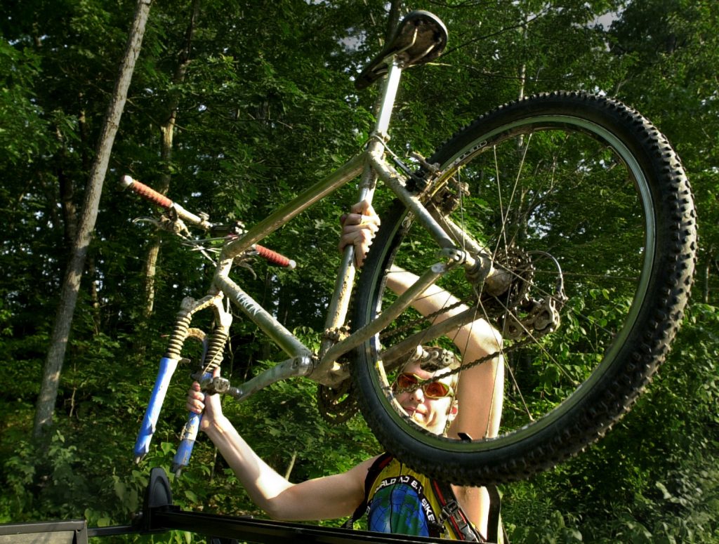 Chris Porter unloads his mountain bike from the car rack in a church parking lot off Rt. 77 in Cape Elizabeth where off some road trails originate.