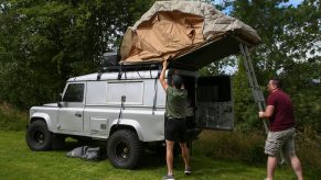two campers setup a rooftop tent